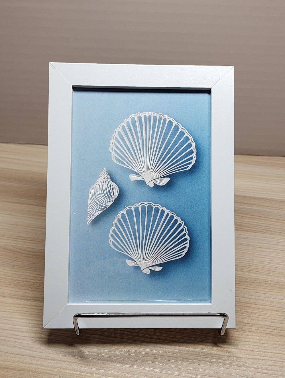 Coastal Shell Wall Art - White Frame, Blue Background